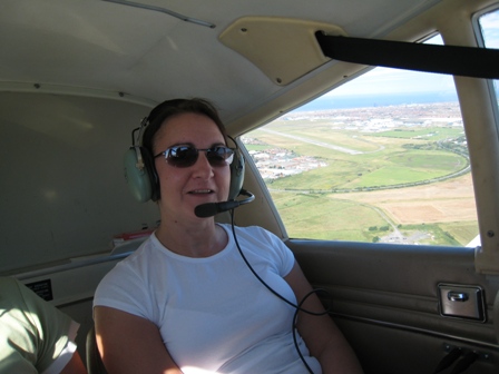 Tracy grinning as the ground drops away