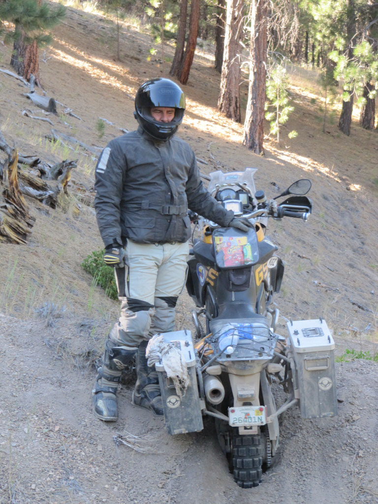 Aaron looking sheepish as his bike is buried up to its chain in dirt