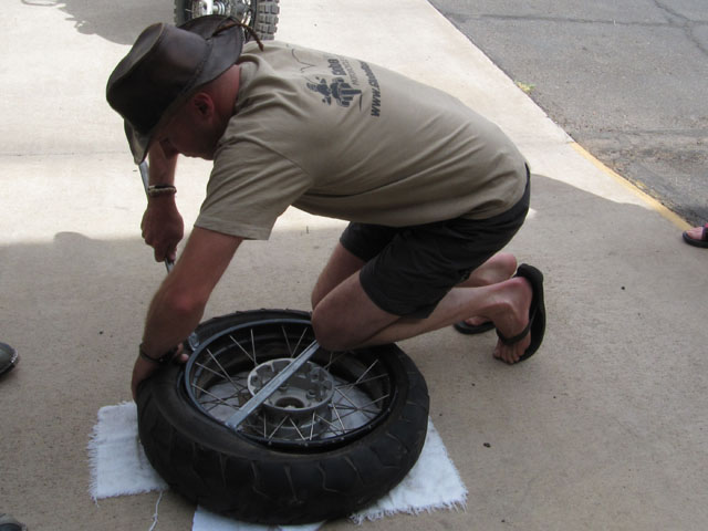 Step 3: Using long tyre levers, heave the leading edge of the old tyre off the rim...