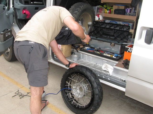 Step 9: Should the tyre refuse to pop the bead onto the rim, try bouncing it hard, then hit it with a rubber mallet...