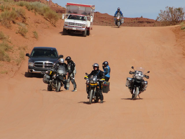 Chaos in the sand, as the guys right Kenny's bike