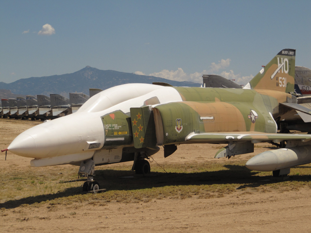 One of the last F4s to enter service in front of row upon row of F4s in storage...