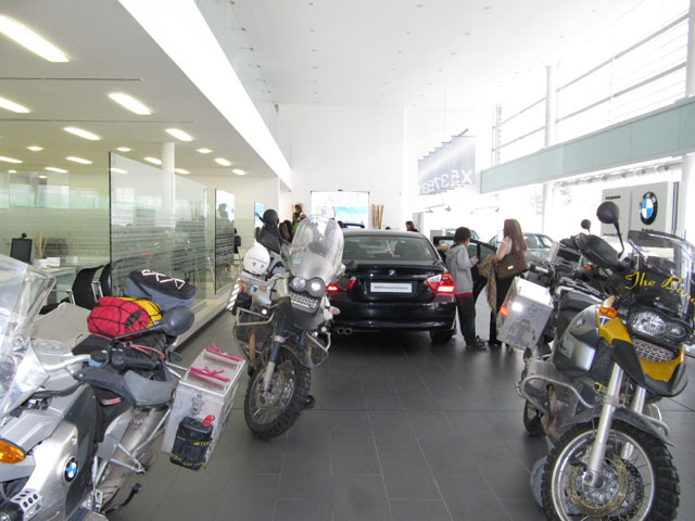 My bike, nestled next to a shiny black BMW 325i...