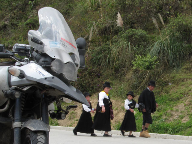 Local Ecuadorians walk past our bikes...