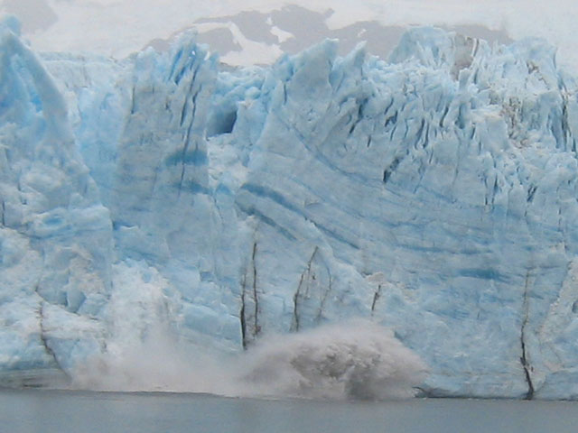 A huge chunk of ice breaks off and crashes into the water