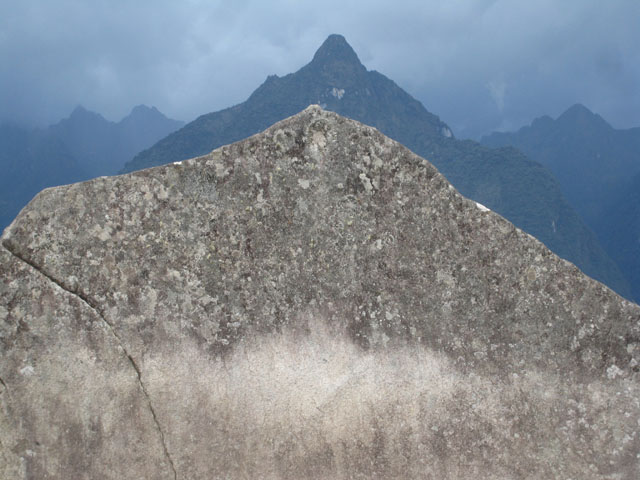 A stone monument, shaped to resemble the mountain behind