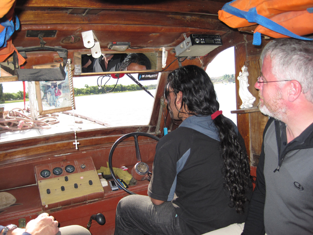Inside the ferry, Simon watches intently in case the driver reaches for his prayer beads...