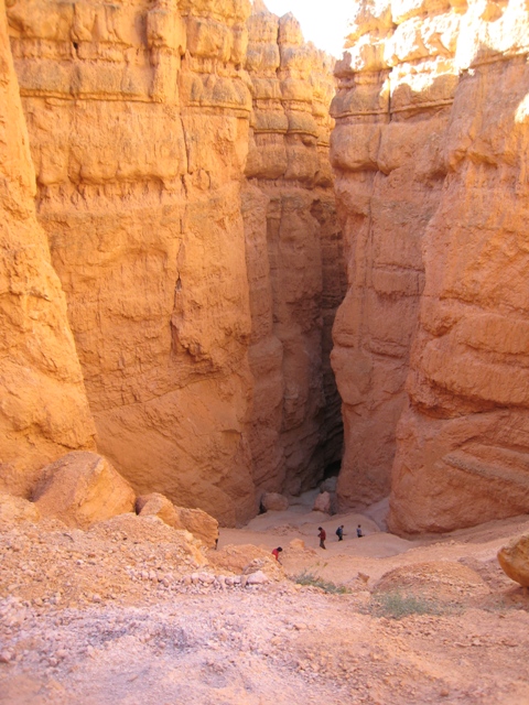 Hikers on the lower part of the Navajo loop get closer to the slot canyon leading into the valley